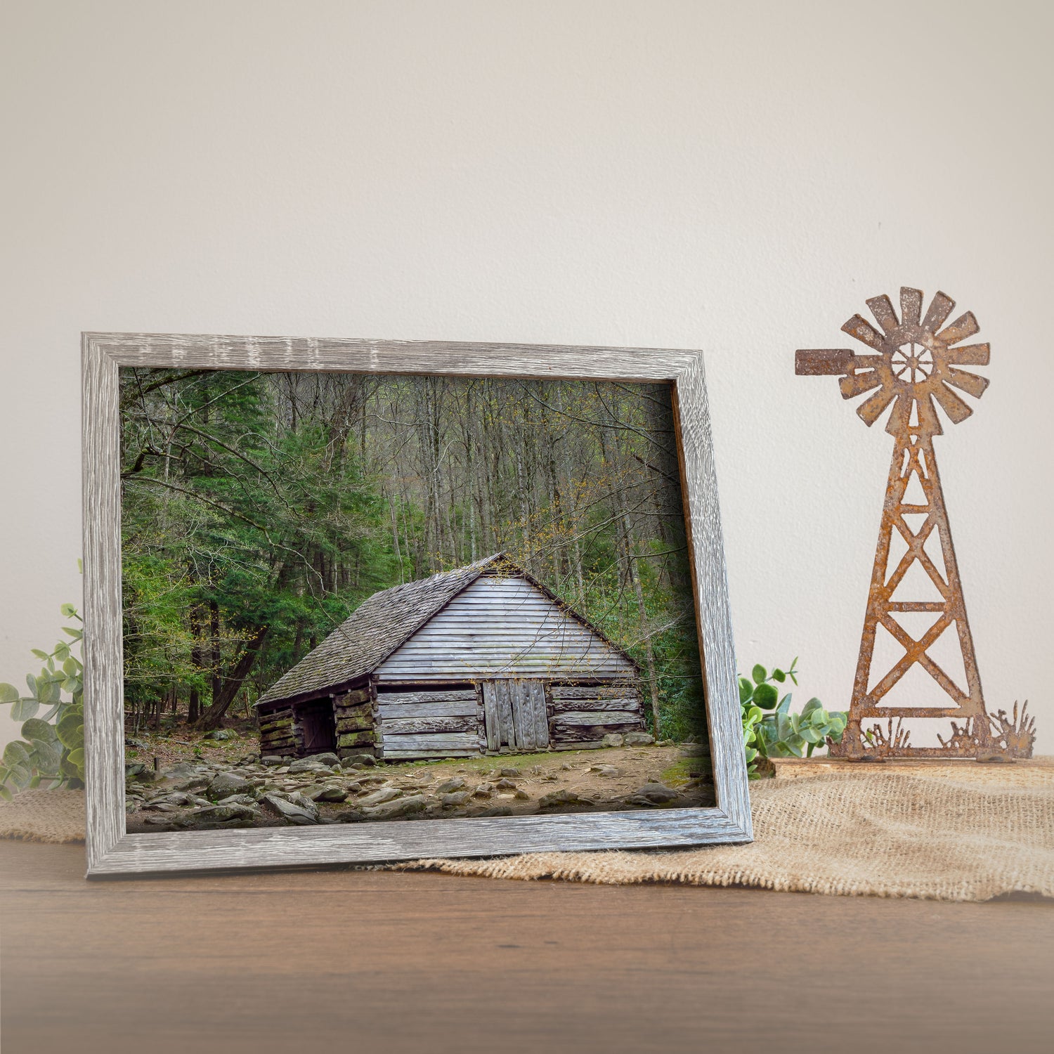 Rustic farmhouse wart print of the historic Bud Ogle Barn in Tennessee, nestled within a lush forest. The barn is in the foreground with detailed forest scenery surrounding it.