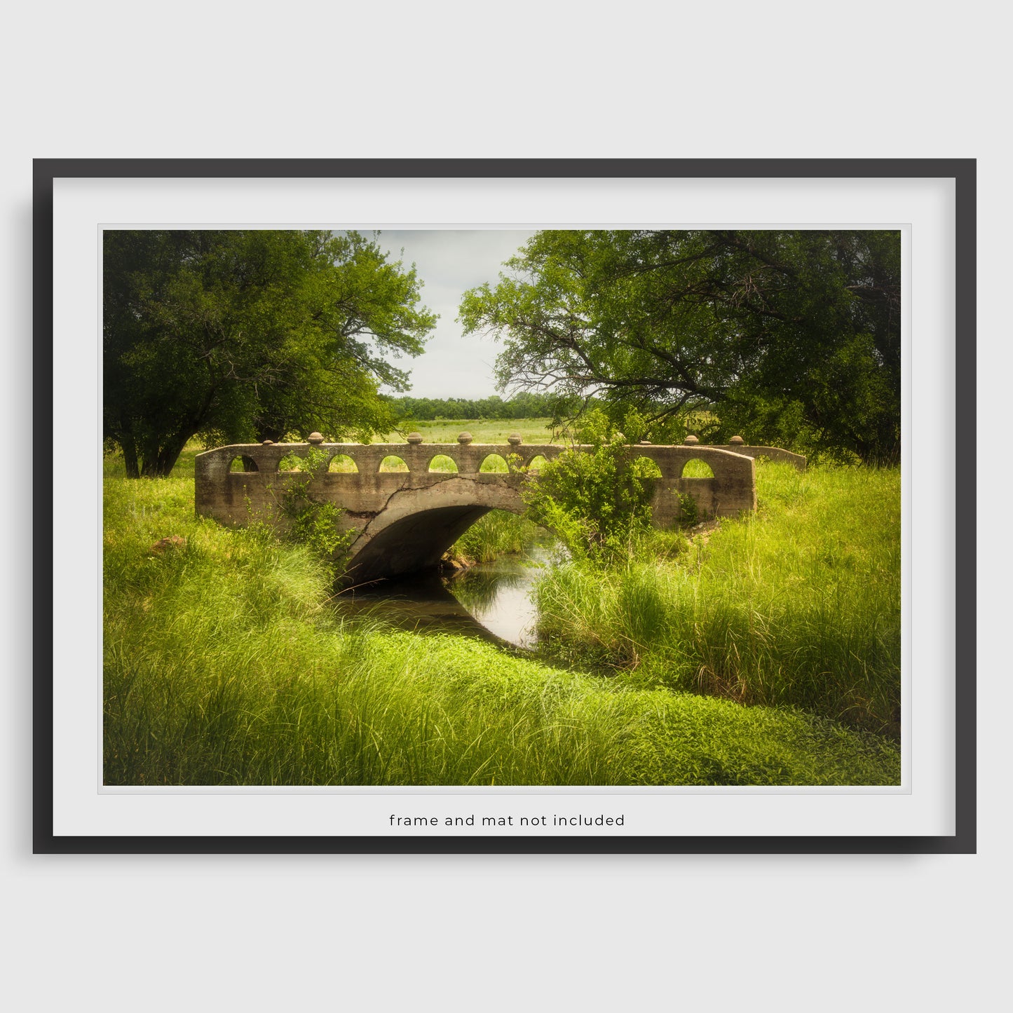Image displaying a Kansas bridge wall art print within a thin black frame and white mat, meant to inspire potential display options. The actual product is the print only; the frame and mat are not included with purchase.