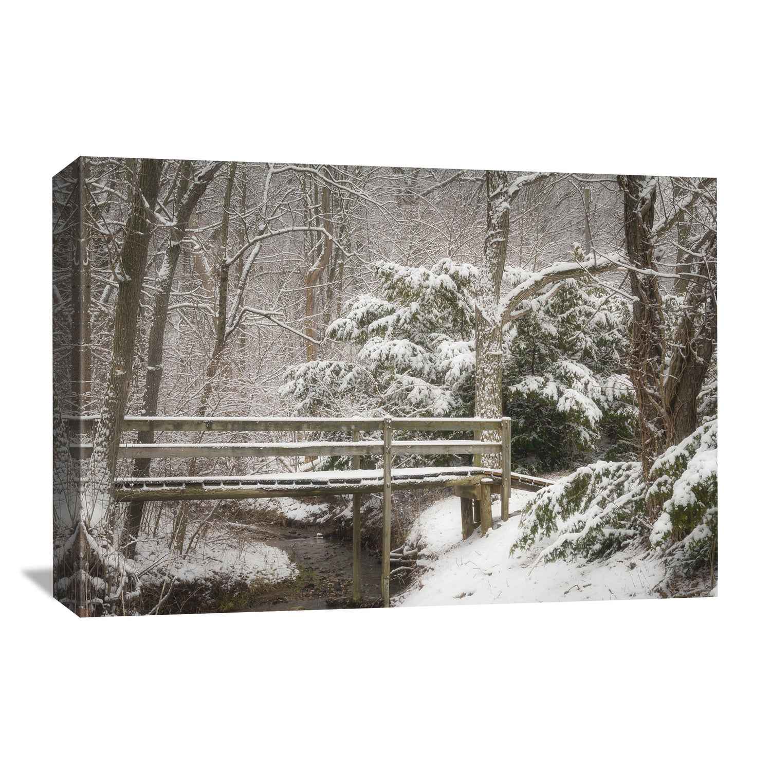 Wall art featuring a winter scene with heavy snow blanketing evergreen trees and a wooden bridge, conjuring the serene essence of a cold, peaceful day in nature.