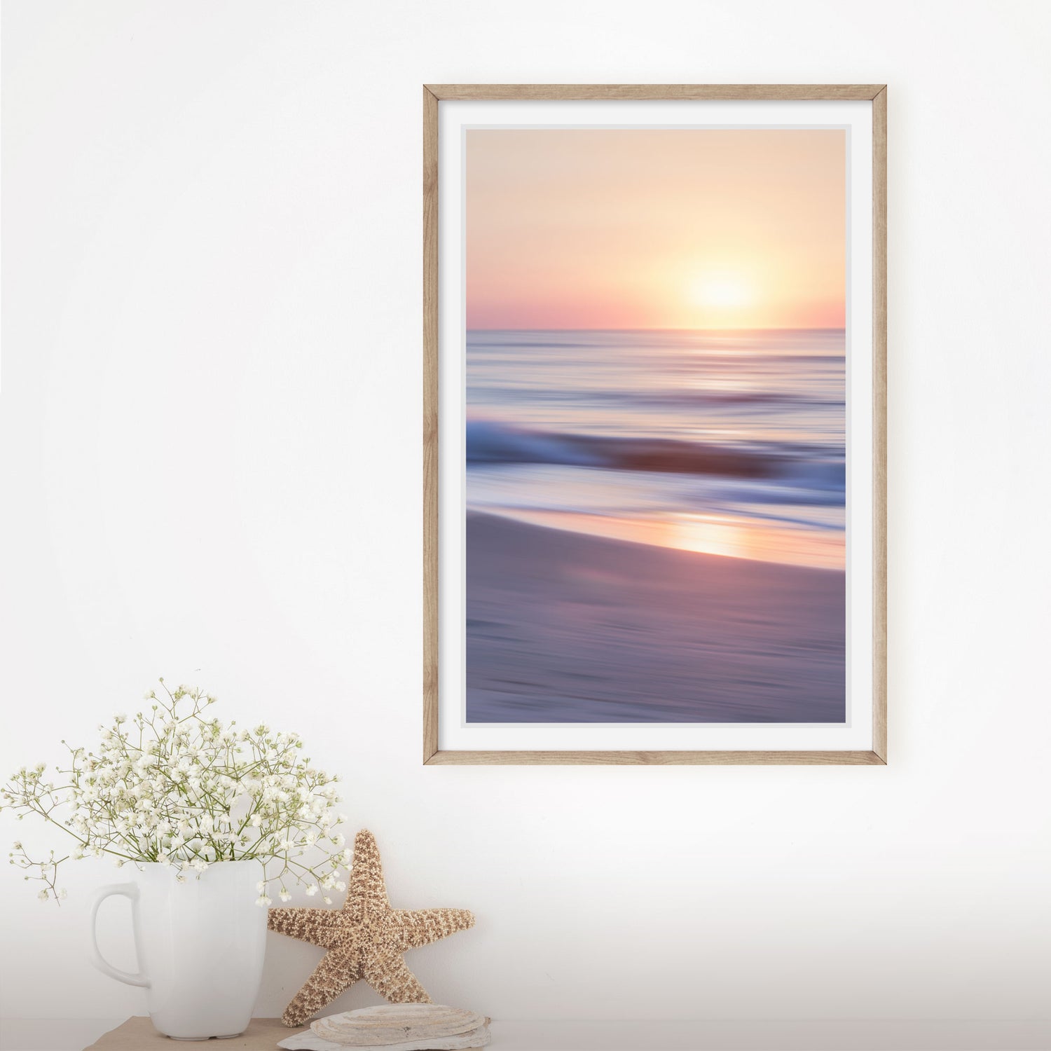 Modern wall art featuring gently rolling waves at sunrise, creating tranquility.