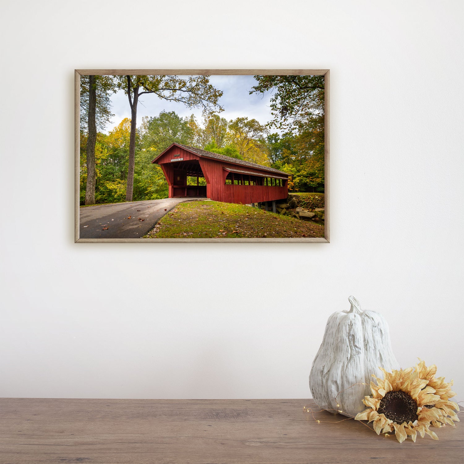 Evoking the charm of rural Ohio, this Nature Photography Print showcases a quintessential Fall view of a Covered Bridge.