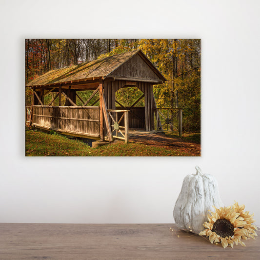 Fall wall art canvas featuring an autumn scene with a covered bridge