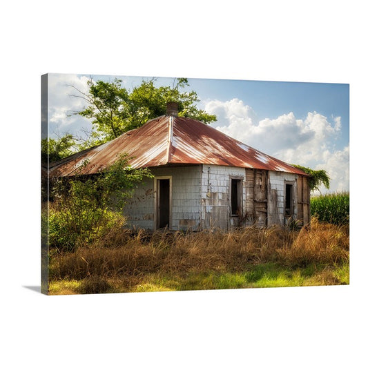 Rustic sharecropper cottage set against a vibrant Mississippi Delta sky.