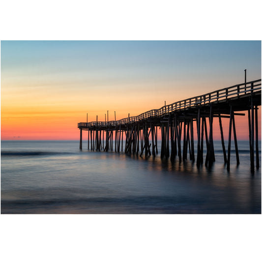 Nature photography print of Avon Pier with a bright, colorful sunrise illuminating the Outer Banks, North Carolina.