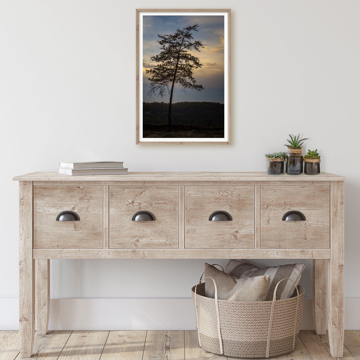 A captivating nature print capturing the silhouette of a single pine tree against the backdrop of an evening sky transitioning from daylight to dusk.